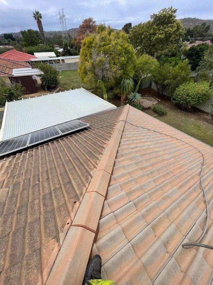 Tile roof work done carefully around solar panels